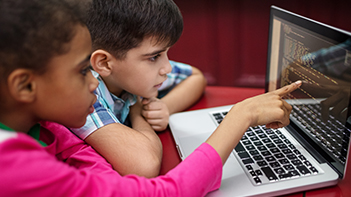 children looking at laptop